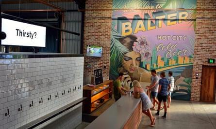 Interior view of Balter microbrewery pub in Currumbin, with people by bar counter.
