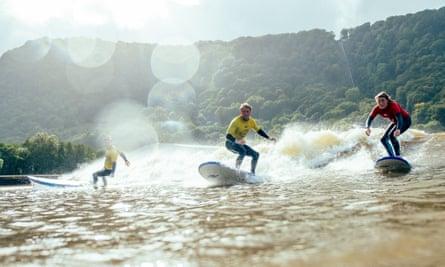 Surfers on the surf lagoon at Adventure Parc Snowdonia