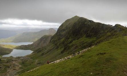 Walkers on the Pyg track up Snowdon, with the railway on the horizon.